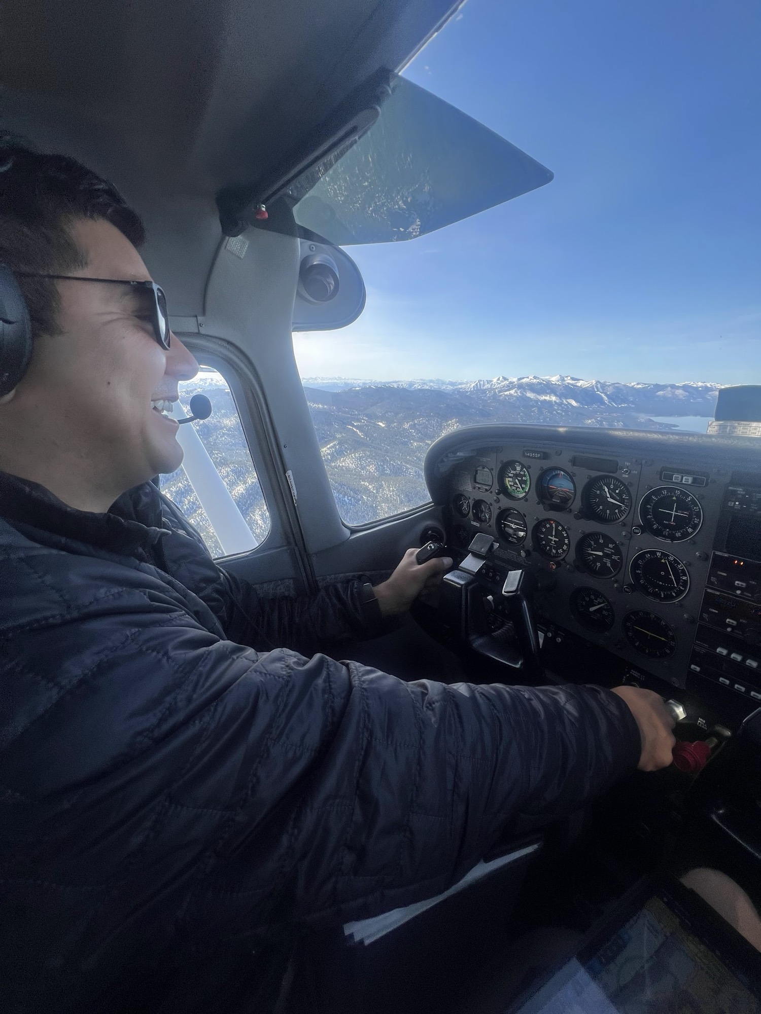 Rob Roderick (Robert Roderick), pilot, at the controls of a Cessna over the snowy Sierra Nevada near Lake Tahoe Rob Roderick (Robert Roderick), pilot, at the controls of a Cessna over the snowy Sierra Nevada near Lake Tahoe